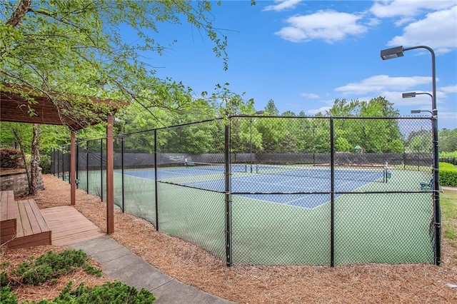 view of sport court with fence