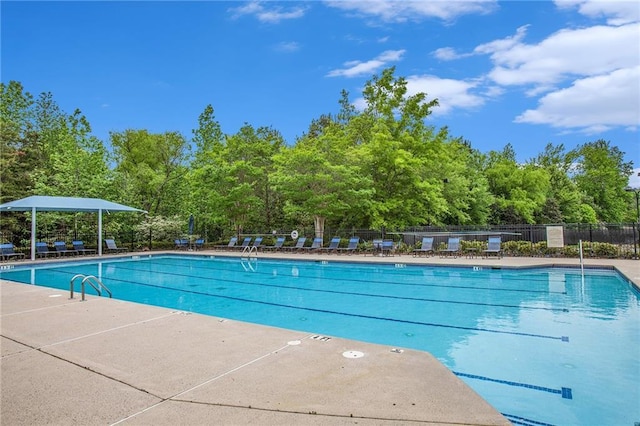 community pool featuring a patio and fence