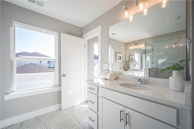 bathroom with a wealth of natural light, tile flooring, and vanity