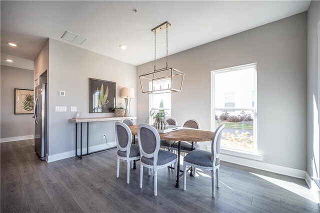 dining room featuring a notable chandelier and dark wood-type flooring