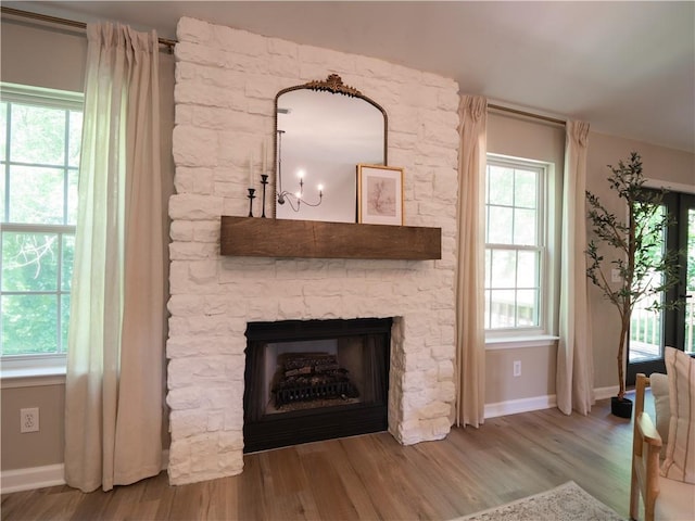 803 Plantation Ridge Overlook, Woodstock, GA 30188 - living area featuring wood finished floors, baseboards, plenty of natural light, and a stone fireplace