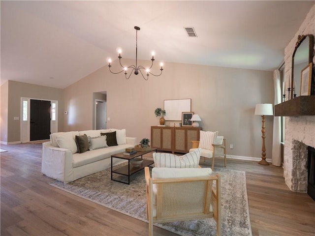 803 Plantation Ridge Overlook, Woodstock, GA 30188 - living room with a chandelier, baseboards, wood finished floors, lofted ceiling, and a fireplace
