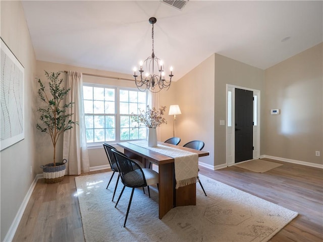 803 Plantation Ridge Overlook, Woodstock, GA 30188 - dining area featuring a chandelier, wood finished floors, lofted ceiling, and baseboards