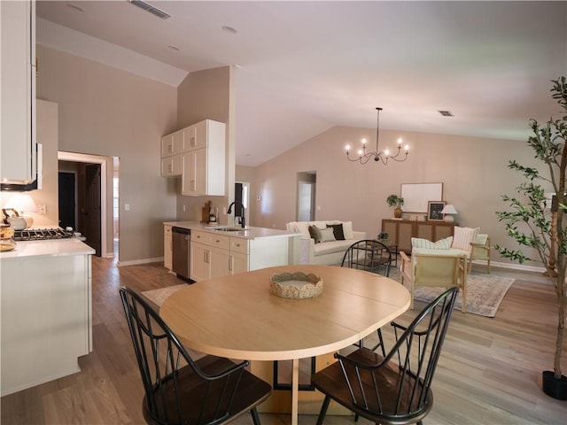 803 Plantation Ridge Overlook, Woodstock, GA 30188 - dining space with lofted ceiling, a chandelier, baseboards, and light wood-style flooring