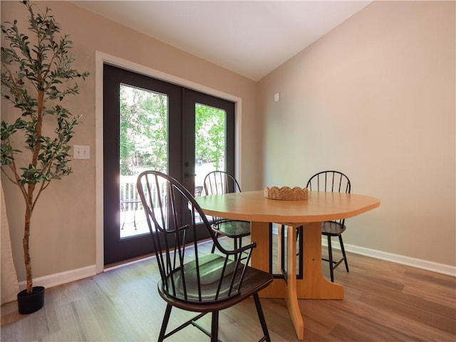 803 Plantation Ridge Overlook, Woodstock, GA 30188 - dining room with french doors, light wood-style flooring, lofted ceiling, and baseboards