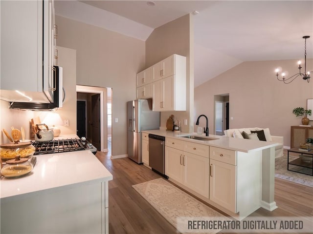 803 Plantation Ridge Overlook, Woodstock, GA 30188 - kitchen featuring a sink, stainless steel appliances, lofted ceiling, light wood-style floors, and white cabinets