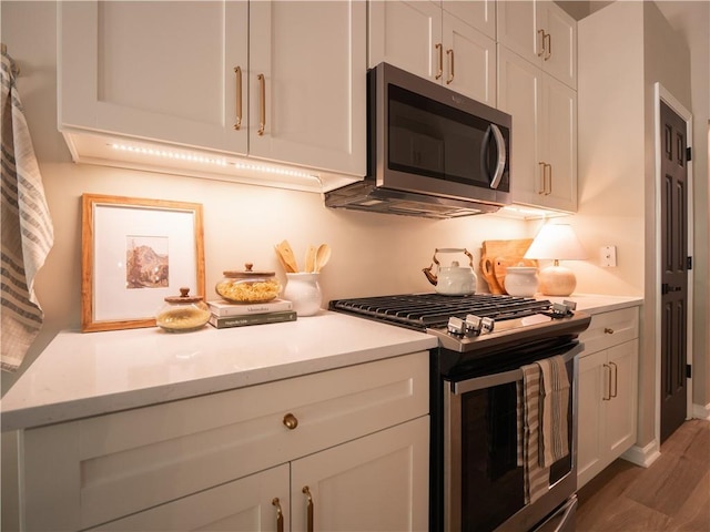 803 Plantation Ridge Overlook, Woodstock, GA 30188 - kitchen featuring appliances with stainless steel finishes, light countertops, and wood finished floors