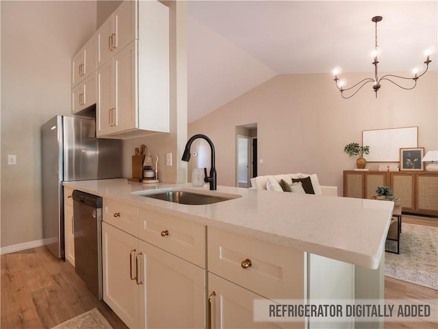 803 Plantation Ridge Overlook, Woodstock, GA 30188 - kitchen featuring a sink, appliances with stainless steel finishes, light wood finished floors, light stone counters, and a chandelier