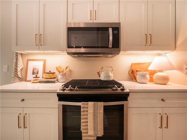 803 Plantation Ridge Overlook, Woodstock, GA 30188 - kitchen with appliances with stainless steel finishes, light countertops, and white cabinets