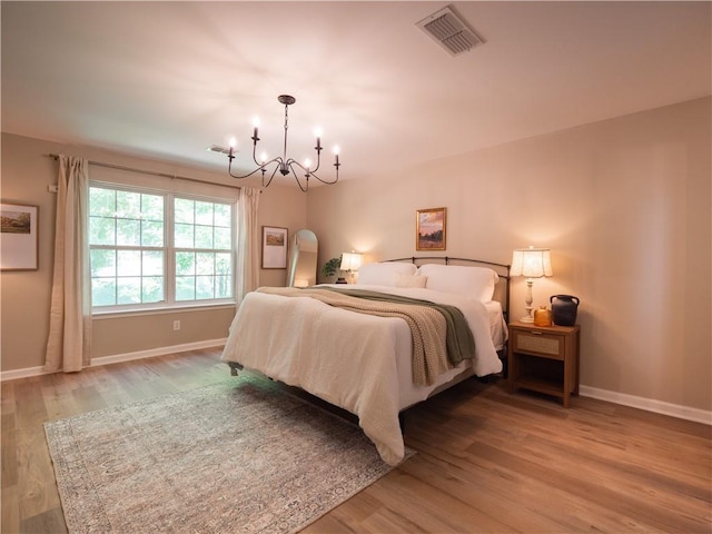 803 Plantation Ridge Overlook, Woodstock, GA 30188 - bedroom with a chandelier, baseboards, and wood finished floors