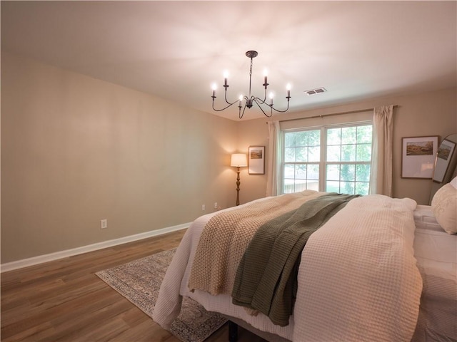 803 Plantation Ridge Overlook, Woodstock, GA 30188 - bedroom featuring a chandelier, wood finished floors, and baseboards