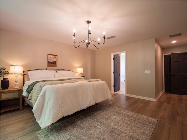 803 Plantation Ridge Overlook, Woodstock, GA 30188 - bedroom with a chandelier, wood finished floors, and baseboards