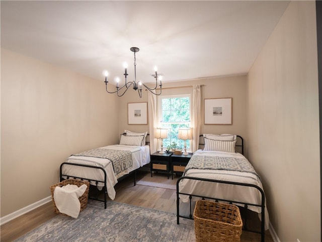 803 Plantation Ridge Overlook, Woodstock, GA 30188 - bedroom featuring a chandelier, wood finished floors, and baseboards