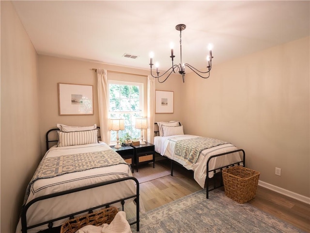 803 Plantation Ridge Overlook, Woodstock, GA 30188 - bedroom featuring a chandelier, wood finished floors, and baseboards