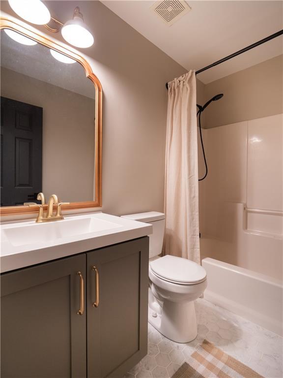 803 Plantation Ridge Overlook, Woodstock, GA 30188 - bathroom with vanity, toilet, shower / tub combo, and tile patterned floors