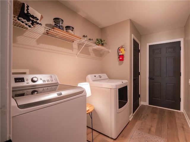803 Plantation Ridge Overlook, Woodstock, GA 30188 - laundry area featuring washing machine and clothes dryer, light wood finished floors, and baseboards