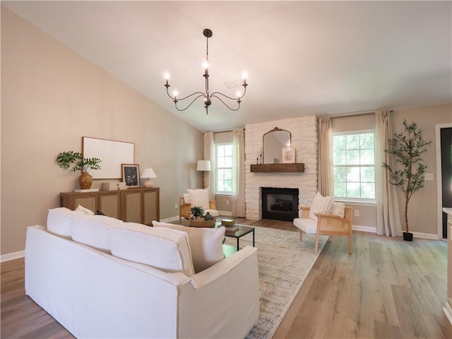 803 Plantation Ridge Overlook, Woodstock, GA 30188 - living room with light wood finished floors, a chandelier, a fireplace, baseboards, and vaulted ceiling