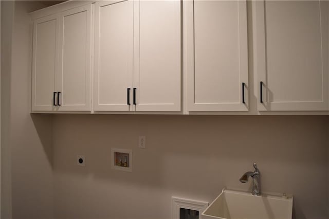 laundry area with hookup for an electric dryer, cabinets, sink, and hookup for a washing machine