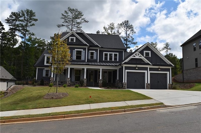 craftsman-style home with a front yard, a porch, and a garage