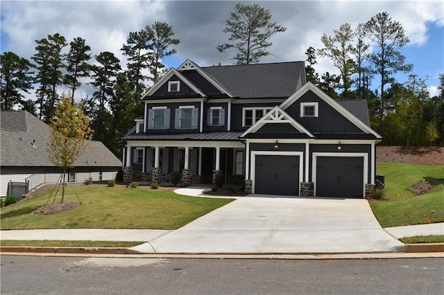 craftsman house with a porch, a garage, and a front lawn