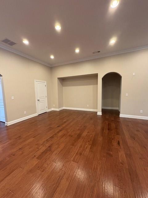 430 La Perla Dr, Sugar Hill, GA 30518 - unfurnished room featuring ornamental molding, arched walkways, dark wood finished floors, and recessed lighting