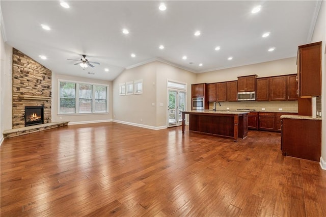 430 La Perla Dr, Sugar Hill, GA 30518 - kitchen with stainless steel appliances, ceiling fan, open floor plan, an island with sink, and healthy amount of natural light