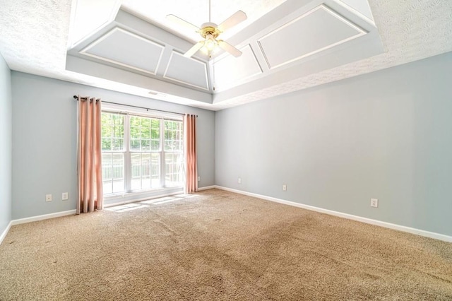 spare room with ceiling fan, carpet floors, and baseboards