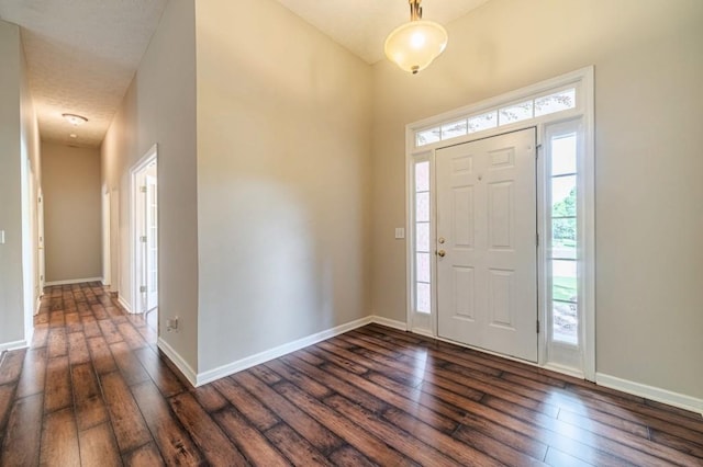 entrance foyer with baseboards and dark wood finished floors