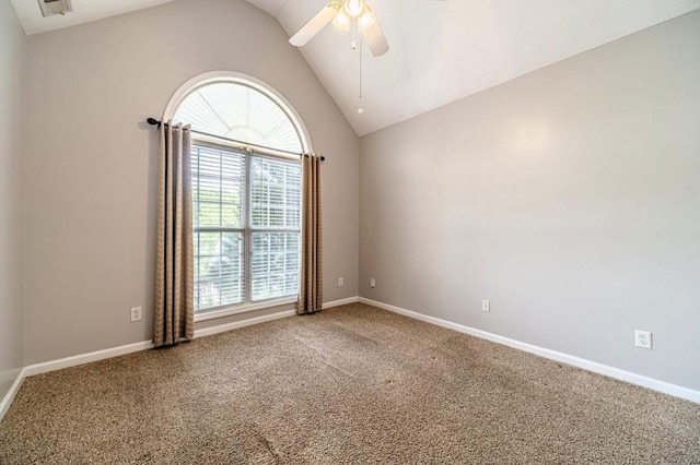 carpeted empty room with a ceiling fan, lofted ceiling, and a healthy amount of sunlight