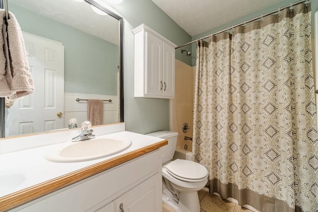 bathroom featuring toilet, tile patterned floors, vanity, and shower / bath combo
