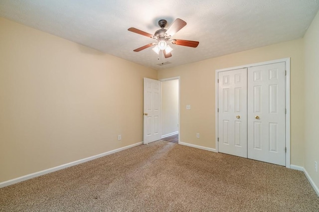 unfurnished bedroom featuring ceiling fan, carpet floors, baseboards, and a closet