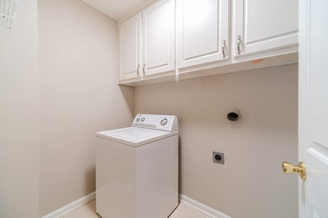 laundry room with cabinet space, light tile patterned floors, baseboards, and washer / clothes dryer