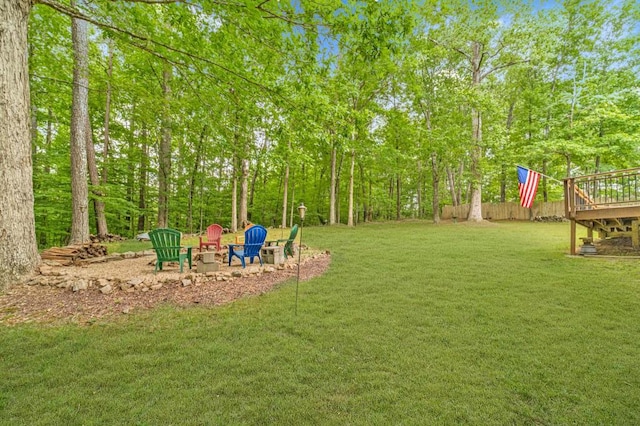 view of yard with an outdoor fire pit and a deck