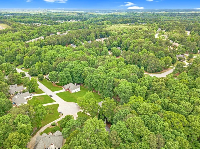 birds eye view of property with a forest view