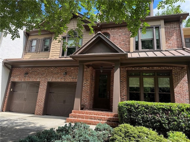 view of front facade with brick siding, a garage, and concrete driveway