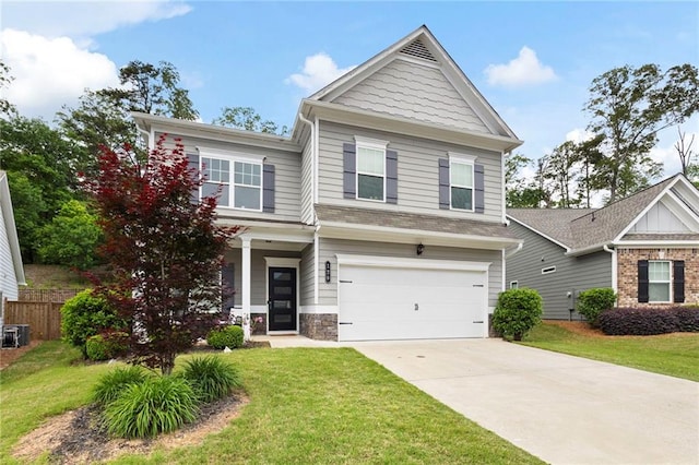 craftsman house with an attached garage, a front yard, and concrete driveway