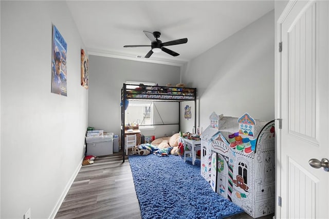 bedroom with baseboards, a ceiling fan, and wood finished floors
