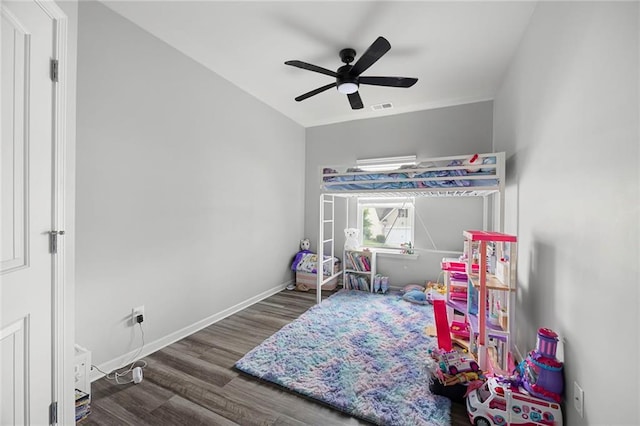 bedroom featuring a ceiling fan, baseboards, visible vents, and wood finished floors