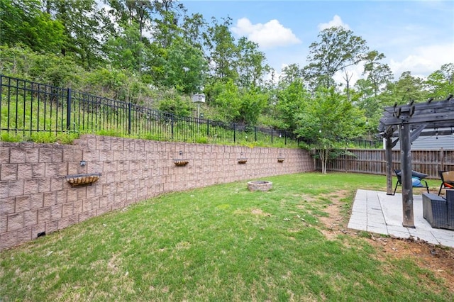 view of yard with a patio, a fenced backyard, a fire pit, and a pergola
