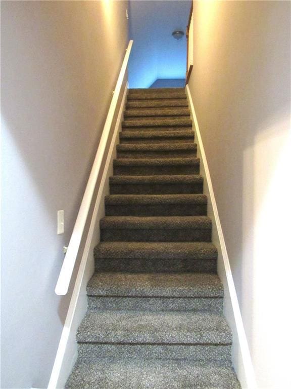 stairway featuring baseboards