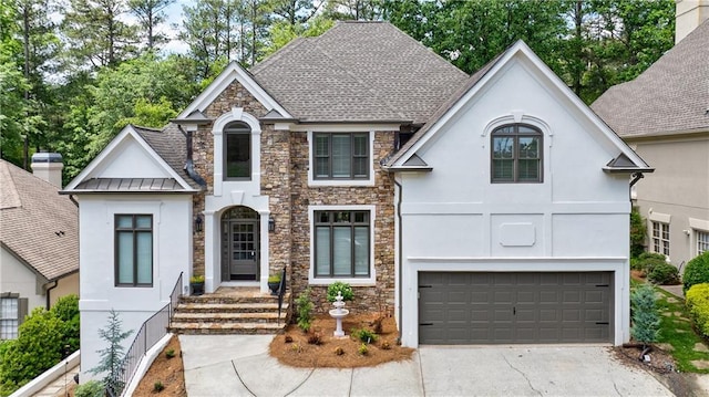 1021 Wetherby Way, Johns Creek, GA 30022 - french country inspired facade featuring stucco siding, stone siding, a standing seam roof, and driveway