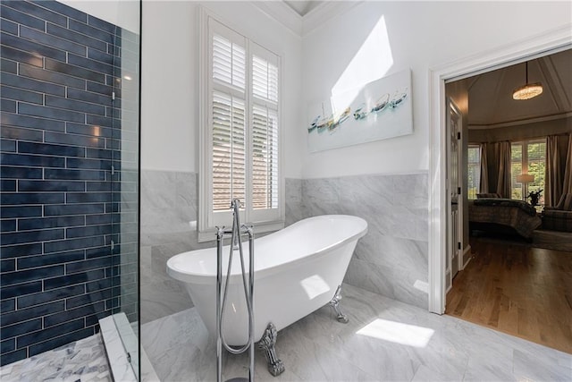 1021 Wetherby Way, Johns Creek, GA 30022 - bathroom with tile walls, healthy amount of natural light, a freestanding tub, crown molding, and wainscoting