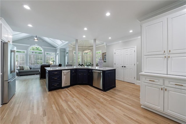1021 Wetherby Way, Johns Creek, GA 30022 - kitchen featuring appliances with stainless steel finishes, open floor plan, white cabinets, ornamental molding, and recessed lighting