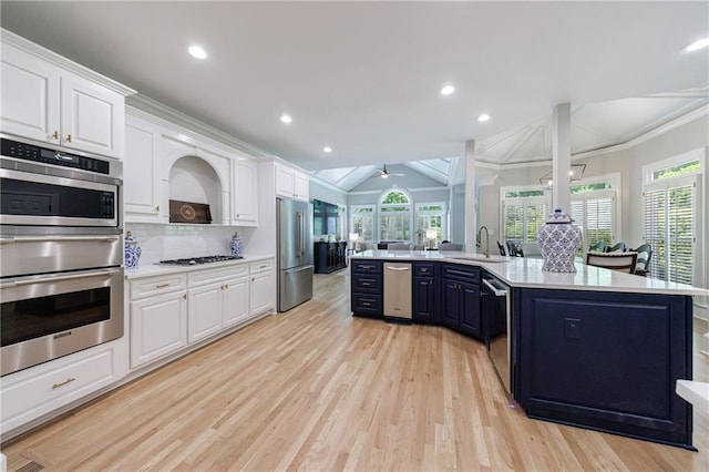 1021 Wetherby Way, Johns Creek, GA 30022 - kitchen with appliances with stainless steel finishes, a sink, light countertops, white cabinetry, and vaulted ceiling