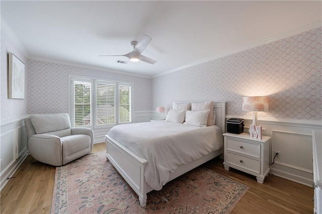 1021 Wetherby Way, Johns Creek, GA 30022 - bedroom featuring crown molding, wallpapered walls, wood finished floors, and ceiling fan