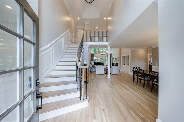 1021 Wetherby Way, Johns Creek, GA 30022 - entrance foyer with ornamental molding, stairway, wood finished floors, a decorative wall, and a high ceiling