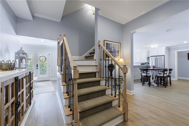 1021 Wetherby Way, Johns Creek, GA 30022 - stairs featuring wood finished floors, ornamental molding, baseboards, recessed lighting, and french doors
