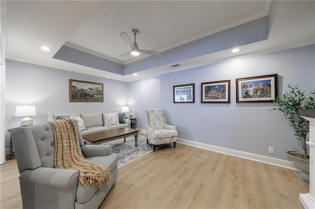 1021 Wetherby Way, Johns Creek, GA 30022 - living room featuring crown molding, a tray ceiling, ceiling fan, light wood-type flooring, and baseboards