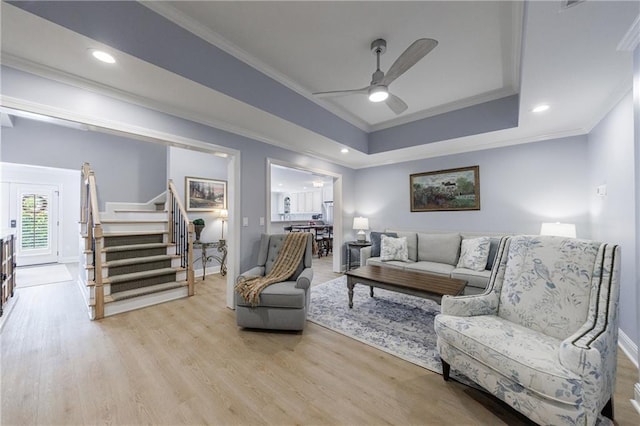 1021 Wetherby Way, Johns Creek, GA 30022 - living room with ornamental molding, baseboards, stairs, a ceiling fan, and light wood finished floors