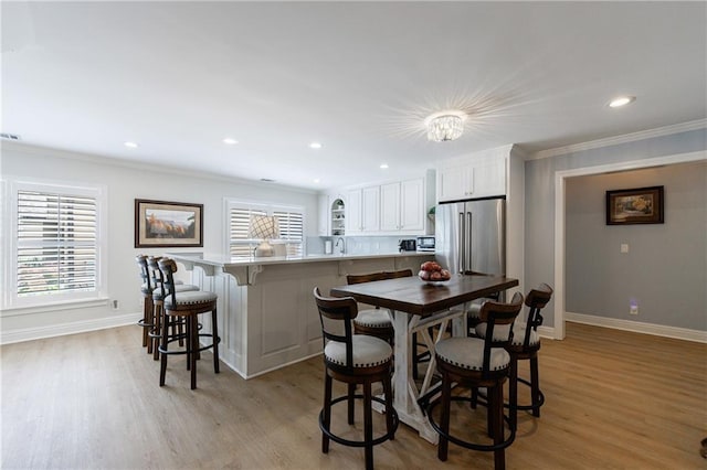 1021 Wetherby Way, Johns Creek, GA 30022 - dining area featuring crown molding, light wood-style flooring, baseboards, and recessed lighting
